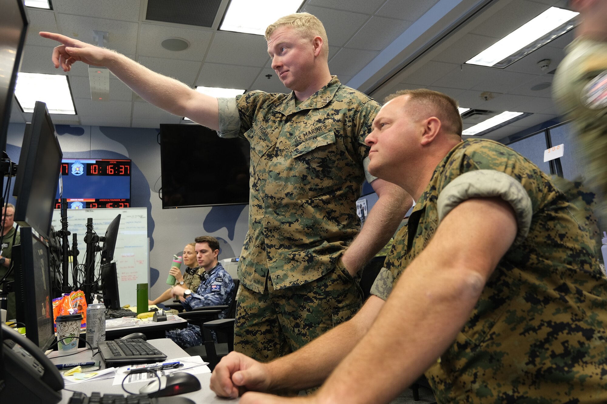 uniformed U.S. Marines work in a virtual simulated environment