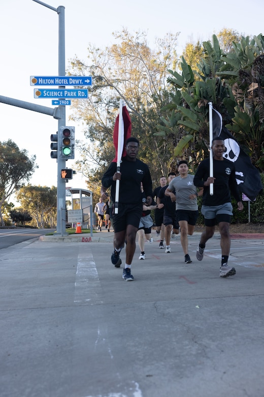 U.S. Marines with Marine Aerial Refueler Transport Squadron (VMGR) 352, Marine Aircraft Group 11, 3rd Marine Aircraft Wing, arrived at their first check point during a Veteran's Day flag run in San Diego, Nov. 7, 2024. The run, spearheaded by Capt. Tyler Chittick, began at MCAS Miramar and will end at the School of Infantry West, Marine Corps Base Camp Pendleton totaling 55 miles of relay run and hike. Each year Chittick brings Marines together to complete a challenging physical activity in honor of fallen and disabled veterans including a fellow Marine who was injured by an improvised explosive device in Afghanistan in 2011. (U.S. Marine Corps photo by Gunnery Sgt. Antonio De La Fuente)