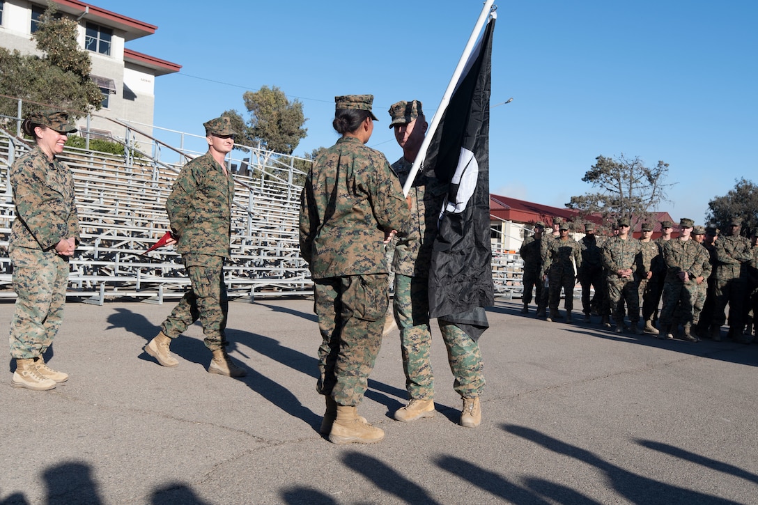 U.S. Marine Corps Capt. Tyler Chittick, front, a KC-130J Super Hercules pilot with Marine Aerial Refueler Transport Squadron (VMGR) 352, Marine Aircraft Group 11, 3rd Marine Aircraft Wing, presents the VMGR-352 flag to the honor graduate of Fox Company, Marine Combat Training, School of Infantry West, during a graduation ceremony after a Veteran's Day flag in San Diego, Nov. 7, 2024. The run, spearheaded by Capt. Tyler Chittick, began at MCAS Miramar and will end at the School of Infantry West, Marine Corps Base Camp Pendleton totaling 55 miles of relay run and hike. Each year Chittick brings Marines together to complete a challenging physical activity in honor of fallen and disabled veterans including a fellow Marine who was injured by an improvised explosive device in Afghanistan in 2011. (U.S. Marine Corps photo by Sgt. Luc Boatman)