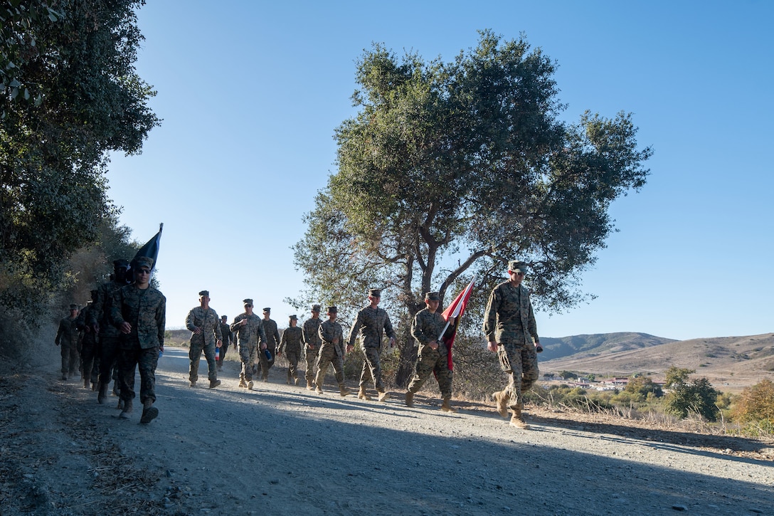 U.S. Marines with Marine Aerial Refueler Transport Squadron (VMGR) 352, Marine Aircraft Group 11, 3rd Marine Aircraft Wing, participate in a Veteran's Day flag run and hike in San Diego, Nov. 7, 2024. The event, spearheaded by Capt. Tyler Chittick, began at MCAS Miramar and will end at the School of Infantry West, Marine Corps Base Camp Pendleton totaling 55 miles of relay run and hike. Each year Chittick brings Marines together to complete a challenging physical activity in honor of fallen and disabled veterans including a fellow Marine who was injured by an improvised explosive device in Afghanistan in 2011. (U.S. Marine Corps photo by Sgt. Luc Boatman)