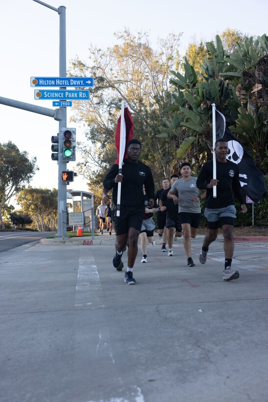 U.S. Marines with Marine Aerial Refueler Transport Squadron (VMGR) 352, Marine Aircraft Group 11, 3rd Marine Aircraft Wing, arrived at their first check point during a Veteran's Day flag run in San Diego, Nov. 7, 2024. The run, spearheaded by Capt. Tyler Chittick, began at MCAS Miramar and will end at the School of Infantry West, Marine Corps Base Camp Pendleton totaling 55 miles of relay run and hike. Each year Chittick brings Marines together to complete a challenging physical activity in honor of fallen and disabled veterans including a fellow Marine who was injured by an improvised explosive device in Afghanistan in 2011. (U.S. Marine Corps photo by Gunnery Sgt. Antonio De La Fuente)