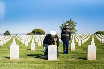 U.S. Marine Corps Col. Jason S. Freeby, the battalion commander of Headquarters and Service Battalion, left, places a wreath upon the headstone of former Sergeant Major of the Marine Corps, Sgt. Maj. Leland D. Crawford, at Fort Rosecrans National Cemetery, San Diego, California, Nov. 10, 2024. The wreath laying ceremonies are a continuing part of the Marine Corps birthday tradition and honor the service to Corps and Country. (U.S. Marine Corps photo by Cpl. Francisco Angel)