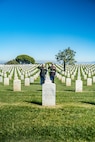 U.S. Marine Corps Col. Jason S. Freeby, the battalion commander of Headquarters and Service Battalion, left, and Sgt. Maj. Thomas A. Bachman, the sergeant major of Headquarters and Service Battalion, right, render a salute to the headstone of former Sergeant Major of the Marine Corps, Sgt. Maj. Leland D. Crawford, at Fort Rosecrans National Cemetery, San Diego, California, Nov. 10, 2024. The wreath laying ceremonies are a continuing part of the Marine Corps birthday tradition and honor the service to Corps and Country. (U.S. Marine Corps photo by Cpl. Francisco Angel)