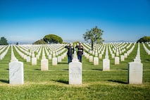 U.S. Marine Corps Col. Jason S. Freeby, the battalion commander of Headquarters and Service Battalion, left, and Sgt. Maj. Thomas A. Bachman, the sergeant major of Headquarters and Service Battalion, right, render a salute to the headstone of former Sergeant Major of the Marine Corps, Sgt. Maj. Leland D. Crawford, at Fort Rosecrans National Cemetery, San Diego, California, Nov. 10, 2024. The wreath laying ceremonies are a continuing part of the Marine Corps birthday tradition and honor the service to Corps and Country. (U.S. Marine Corps photo by Cpl. Francisco Angel)
