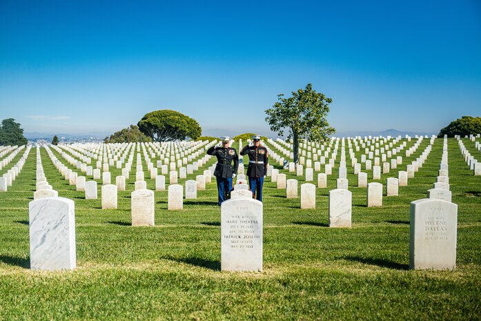 U.S. Marine Corps Col. Jason S. Freeby, the battalion commander of Headquarters and Service Battalion, left, and Sgt. Maj. Thomas A. Bachman, the sergeant major of Headquarters and Service Battalion, right, render a salute to the headstone of former Sergeant Major of the Marine Corps, Sgt. Maj. Leland D. Crawford, at Fort Rosecrans National Cemetery, San Diego, California, Nov. 10, 2024. The wreath laying ceremonies are a continuing part of the Marine Corps birthday tradition and honor the service to Corps and Country. (U.S. Marine Corps photo by Cpl. Francisco Angel)