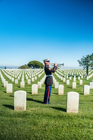 U.S. Marine Corps Sgt. Hunter Rockhill, a musician with the Marine Band San Diego, plays Taps during the wreath laying ceremony for former Sergeant Major of the Marine Corps, Sgt. Maj. Leland D. Crawford, at Fort Rosecrans National Cemetery, San Diego, California, Nov. 10, 2024. The wreath laying ceremonies are a continuing part of the Marine Corps birthday and tradition and honor the service to Corps and Country. (U.S. Marine Corps photo by Cpl. Francisco Angel)