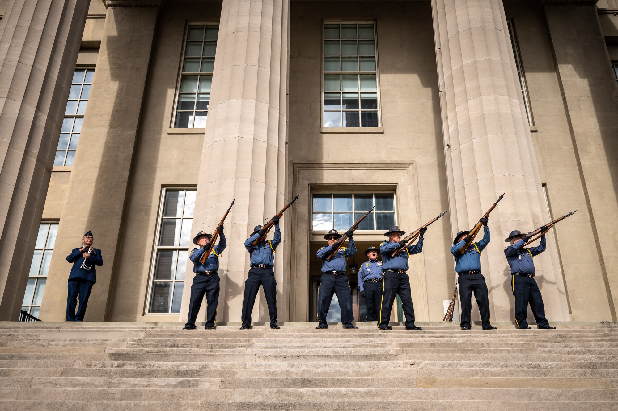 Members of the Veterans of Foreign Wars Post 1170 render a rifle salute on the steps of Metro Hall during the annual Veterans Day Parade in downtown Louisville, Ky., Nov. 9, 2024. The event featured appearances by more than 50 organizations, including the Kentucky Air National Guard and its Mini C-130 Hercules scale replica. (U.S. Air National Guard photo by Dale Greer)