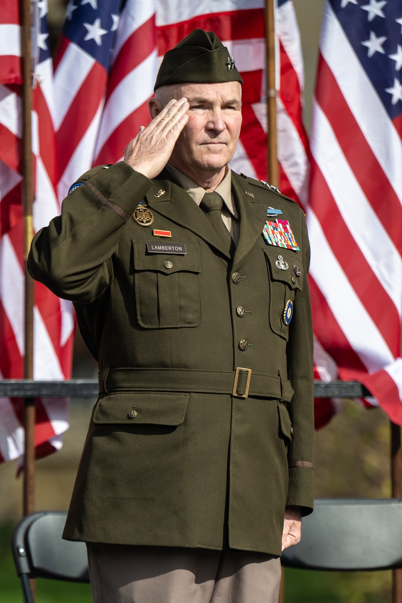 U.S. Army Maj. Gen. Haldane Lamberton, adjutant general of the Kentucky National Guard, renders a salute during the playing of the National Anthem at the opening ceremony of the annual Veterans Day Parade in downtown Louisville, Ky., Nov. 9, 2024. The event featured appearances by more than 50 organizations, including the Kentucky Air National Guard and its Mini C-130 Hercules scale replica. (U.S. Air National Guard photo by Dale Greer)