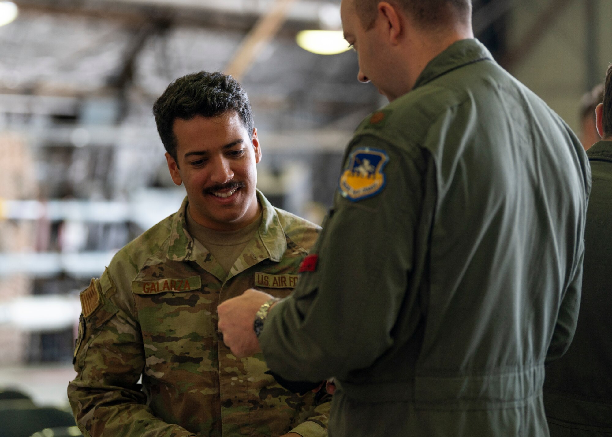 U.S. Air Force Maj. Justin Goar, right, 51st Fighter Wing director of staff, gives a patch to Staff Sgt. Allen Galarza, 36th Fighter Generation Squadron dedicated crew chief, after a Dedicated Crew Chief Ceremony at Osan Air Base, Republic of Korea, Oct. 25, 2024. The DCCs and pilots work together to ensure the aircraft they are responsible for takes off and lands safely. Their cooperative relationship is another reason the 36th Fighter Squadron and 36th FGS are always ready to “Fight Tonight” and defend the peninsula. (U.S. Air Force photo by Staff Sgt. Ashley N. Mikaio)