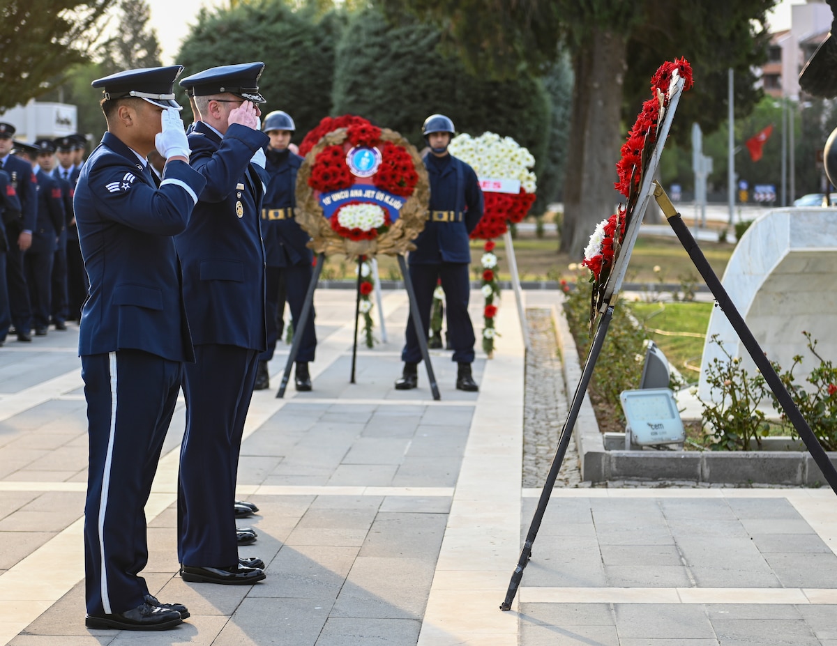 Members of the U.S. Air Force render a salute to a wreath during a ceremony