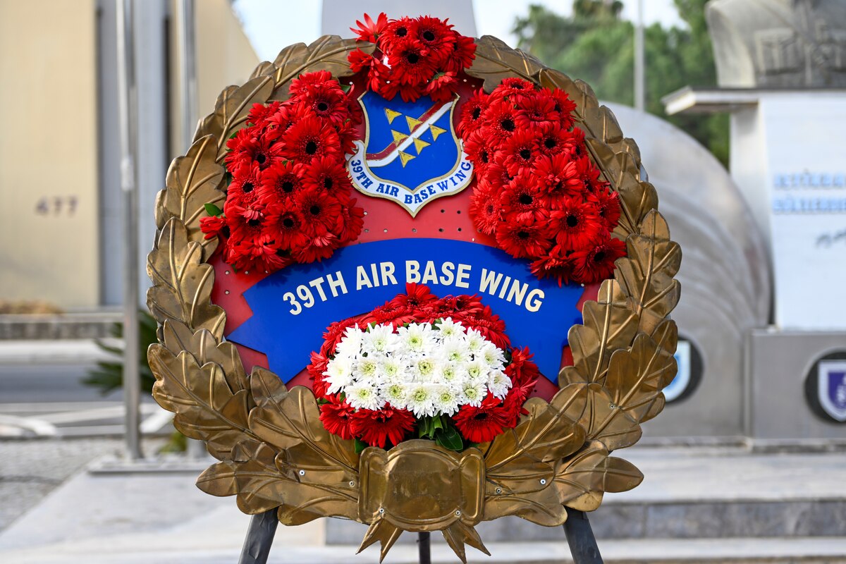 A wreath with the 39th Air Base Wing emblem is displayed during a ceremony