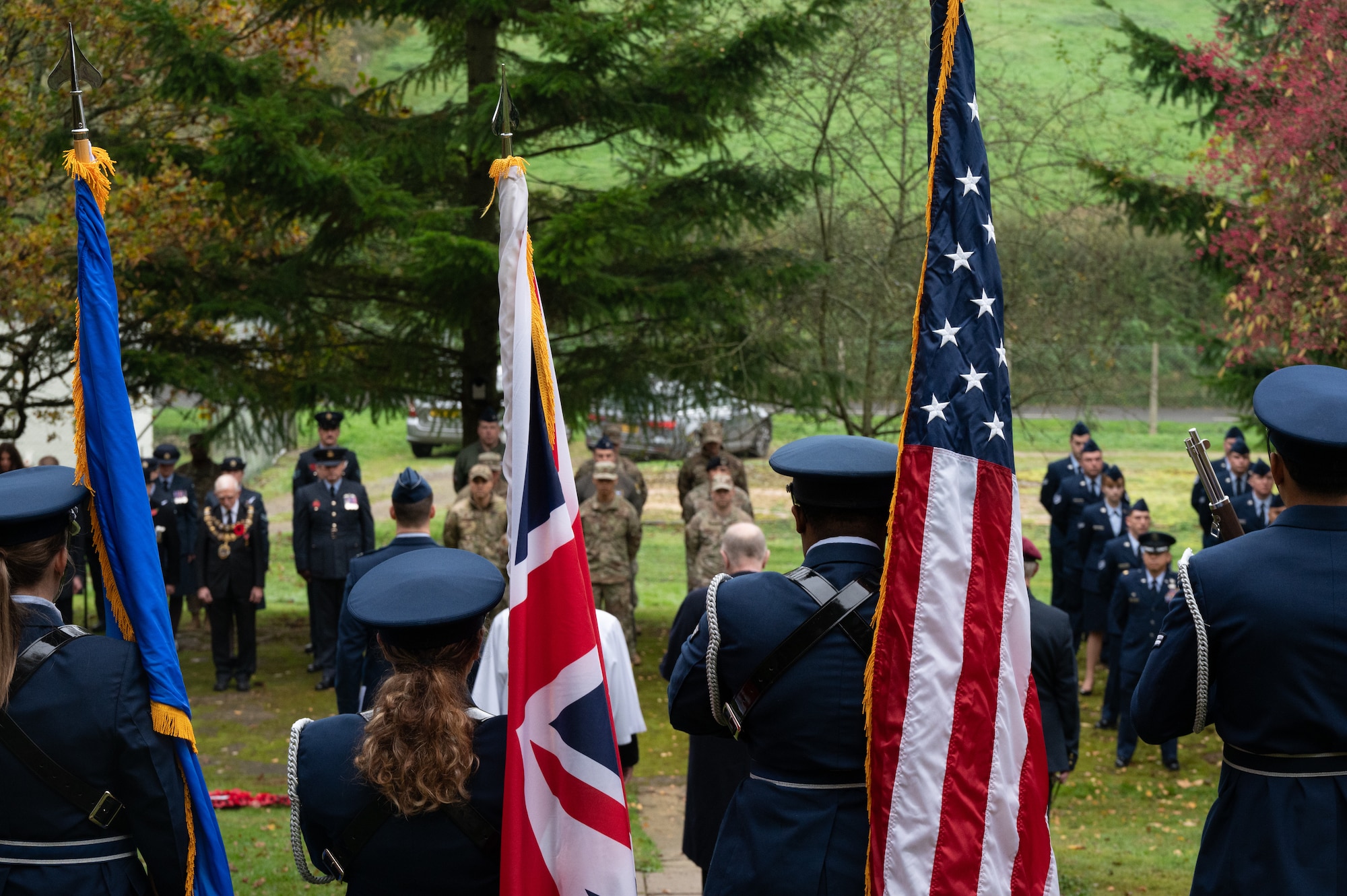 Service members and guests stand