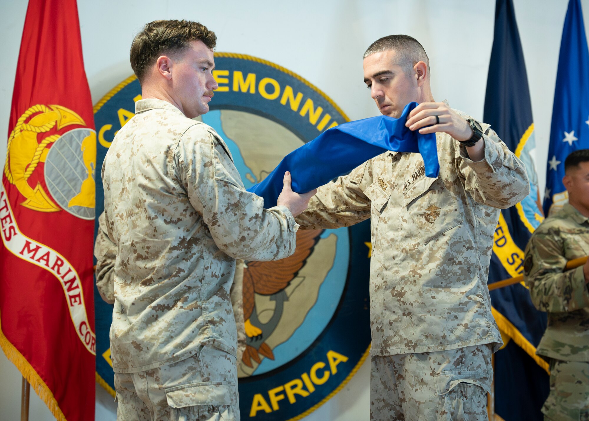 Members of Marine Air Control Squadron 2 case their guidon.