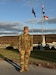 U.S. Army 1st Lt. Sarah M. Joseph, a behavioral health officer with the Medical Readiness Detachment, Joint Force Headquarters, Pennsylvania National Guard, smiles under Pennsylvania and American flags at Fort Indiantown Gap, Pennsylvania, Nov. 2, 2024. Joseph recently commissioned after a five-year break in service. (U.S. Army National Guard photo by 1st Sgt. HollyAnn Nicom)