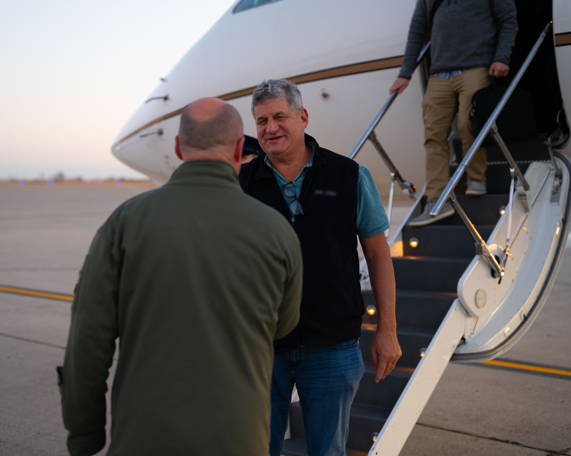 Col. Benjamin Jensen, 5th Bomb Wing deputy commander, (left) greets Dr. William LaPlante, Under Secretary of Defense for Acquisition and Sustainment, arrives at Minot Air Force Base, North Dakota, Oct. 30, 2024. LaPlante's role encompasses oversight of acquisition policies, defense logistics and the readiness of installations to support mission success. (U.S. Air Force photo by Airman 1st Class Luis Gomez)