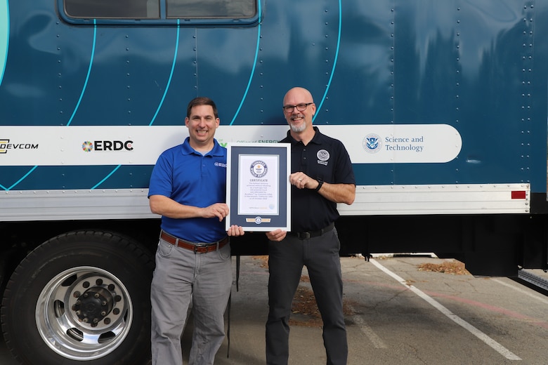 DHS S&T's Ron Langhelm and ERDC's Nick Josefik standing with title certificate and H2Rescue