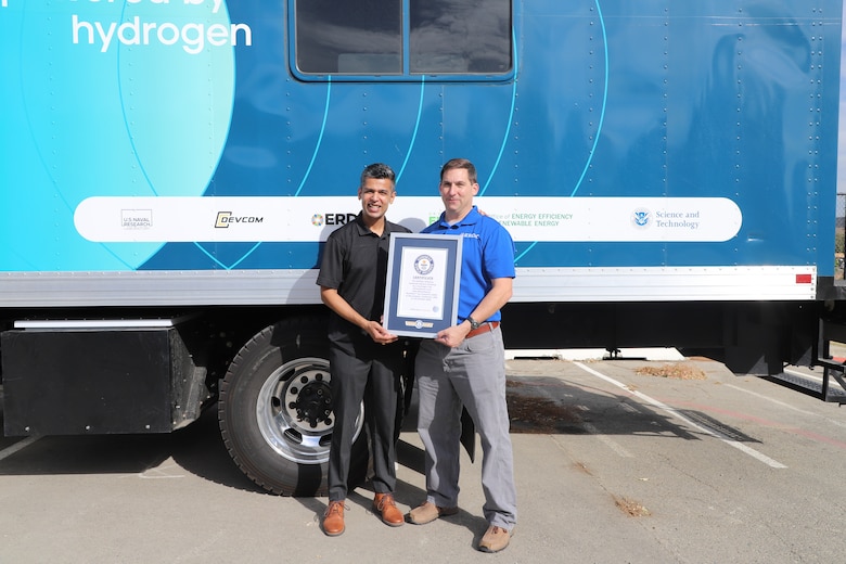 Accelera™ by Cummins' Prateek Vaish and ERDC's Nick Josefik standing with title certificate and H2Rescue