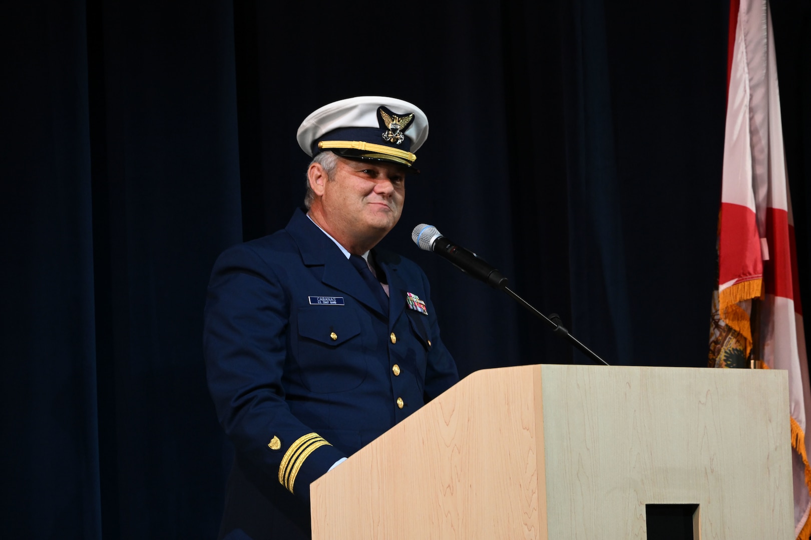 Coast Guard JROTC instructor retired Lt. Cmdr. George Cabanas addresses guests during the establishment ceremony of the Coast Guard Junior Reserve Officers' Training Corps (JROTC) unit at Innovation High School Orlando, Florida, Nov. 8, 2024. Innovation High School’s Coast Guard JROTC unit is the 12th in the nation and is the largest to-date, with over 190 cadets enrolled in the inaugural semester. (U.S. Coast Guard photo by Petty Officer 1st Class Riley Perkofski)