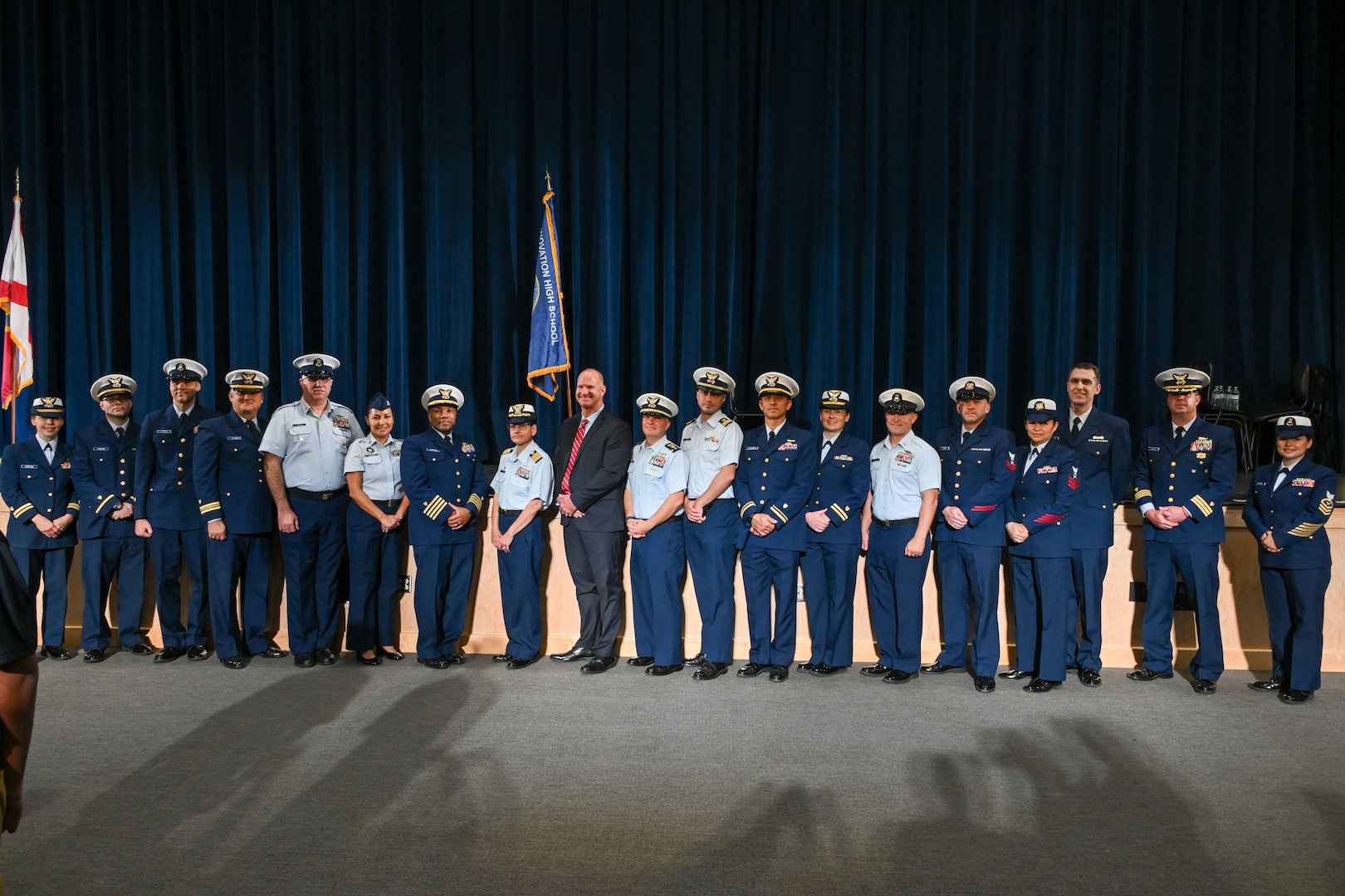 Coast Guard Capt. Willie Carmichael, Cmdr. Clay Cromer, and high school student cadet leaders conduct the ceremony for the establishment of the Coast Guard Junior Reserve Officers' Training Corps (JROTC) unit at Innovation High School Orlando, Florida, Nov. 8, 2024. Innovation High School’s Coast Guard JROTC unit is the 12th in the nation and is the largest to-date, with over 190 cadets enrolled in the inaugural semester. (U.S. Coast Guard photo by Petty Officer 1st Class Riley Perkofski)