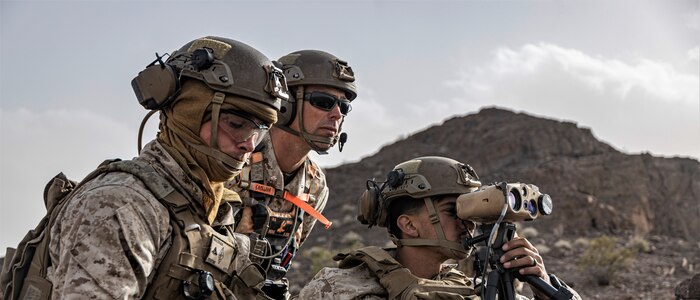 U.S. Marines with 1st Battalion, 1st Marine Regiment, 1st Marine Division, determine the distance of targets during the simultaneous ground assault portion of Marine Air Ground Task Force Distributed Maneuver Exercise (MDMX) on Marine Corps Air Ground Combat Center, Twentynine Palms, California, Feb. 14, 2023. MDMX is a maneuver exercise that incorporates air, ground, and logistics operations to create favorable conditions for the Joint Force. (U.S. Marine Corps photo by Sgt. Armando Elizalde)