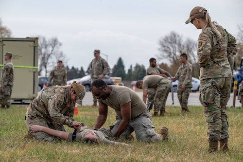 U.S. Air Force Senior Airman Zoey Baylor, right, 436th Logistics Readiness Squadron warehouse operations apprentice, supervises a team of Airmen performing Tactical Combat Casualty Care procedures during the LRS Mission Ready Airman Rodeo at Dover Air Force Base, Delaware, Nov. 7, 2024. The Rodeo consisted of three events intended to prepare Airmen for the future fight and meet MRA qualifications in a competitive, engaging and safe competition. (U.S. Air Force photo by Senior Airman Amanda Jett)