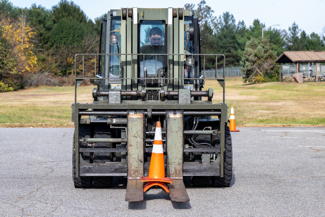 U.S. Air Force Senior Airman Joseph Gilmour, 436th Logistics Readiness Squadron ground transportation operator, picks up cones with a forklift during the LRS Mission Ready Airman Rodeo at Dover Air Force Base, Delaware, Nov. 7, 2024. The Rodeo consisted of three events intended to prepare Airmen for the future fight and meet MRA qualifications in a competitive, engaging and safe competition. (U.S. Air Force photo by Senior Airman Amanda Jett)