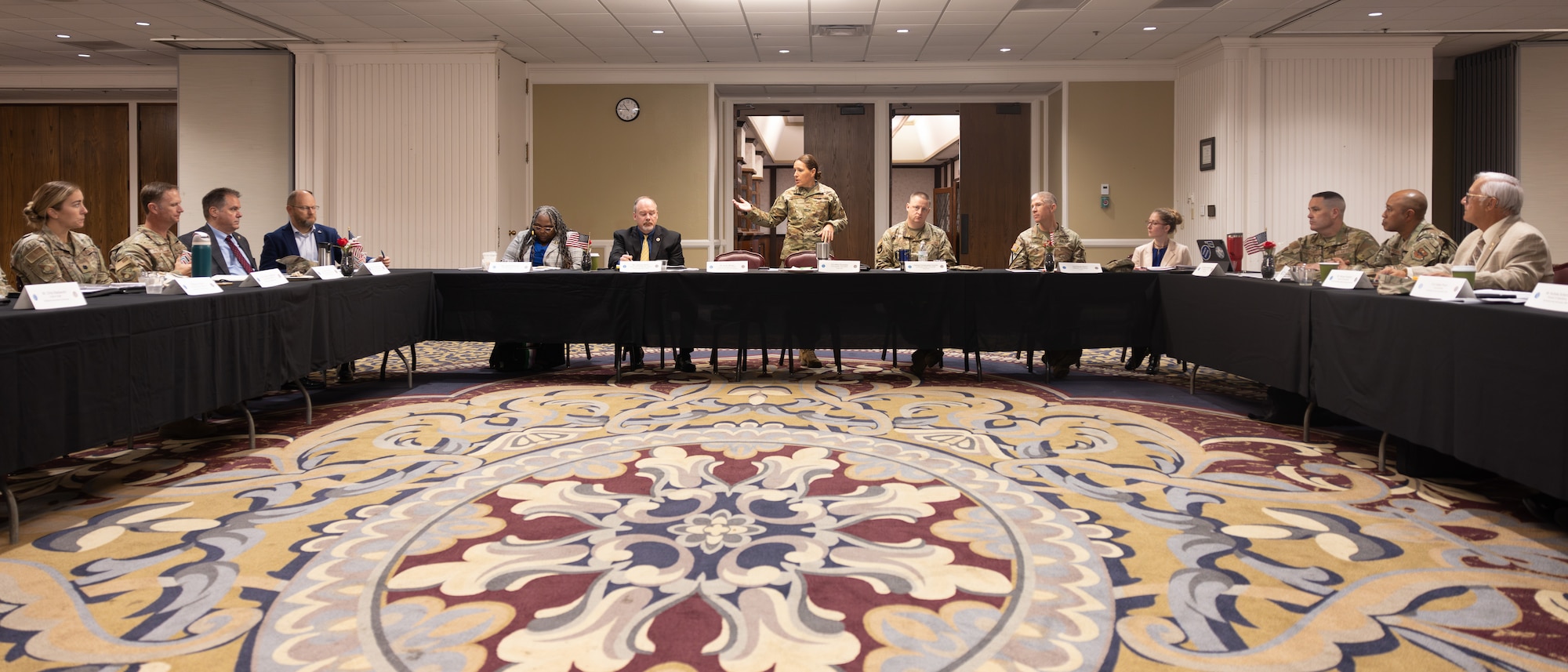 Thirteen people at u-shaped table
