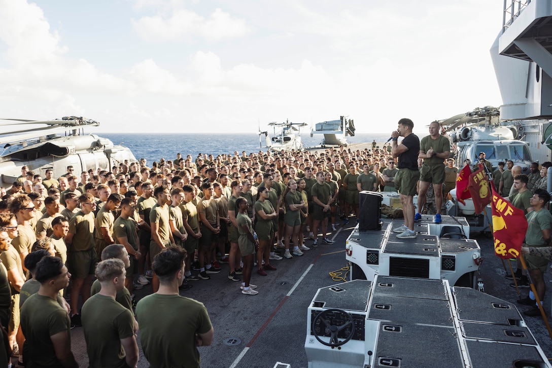 U.S. Marine Corps Gunnery Sgt. Joseph Morelli, the communications maintenance chief and force fitness instructor assigned to the 15th Marine Expeditionary Unit, and a native of Wyoming, explains the order of exercises to Marines during a physical training competition aboard the amphibious assault ship USS Boxer (LHD 4) in the Pacific Ocean Nov. 10, 2024. The PT competition was held on the second day of the 15th MEU’s 249th Marine Corps birthday celebrations as Boxer transited past the international dateline.  Elements of the 15th MEU are currently embarked aboard Boxer and are conducting routine operations in U.S. 3rd Fleet. (U.S. Marine Corps photo by Cpl. Joseph Helms)
