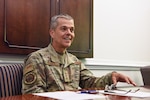 Image of an Airman sitting at a table.