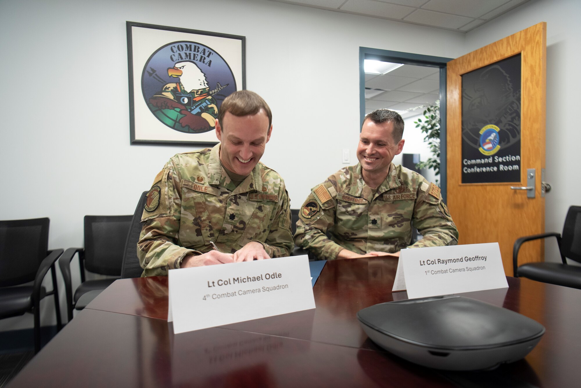 Lt Col. Michael Odle, commander of the 4th Combat Camera Squadron (4CTCS) signs a Memorandum of Understanding with Lt. Col. Raymond Geoffroy, commander of the 1st Combat Camera Squadron (1CTCS) on Nov. 2, 2024 at Joint Base Charleston, S.C.