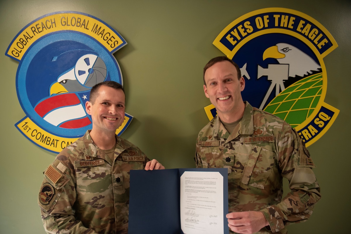 Lt Col. Michael Odle, commander of the 4th Combat Camera Squadron (4CTCS) signs a Memorandum of Understanding with Lt. Col. Raymond Geoffroy, commander of the 1st Combat Camera Squadron (1CTCS) on Nov. 2, 2024 at Joint Base Charleston, S.C.