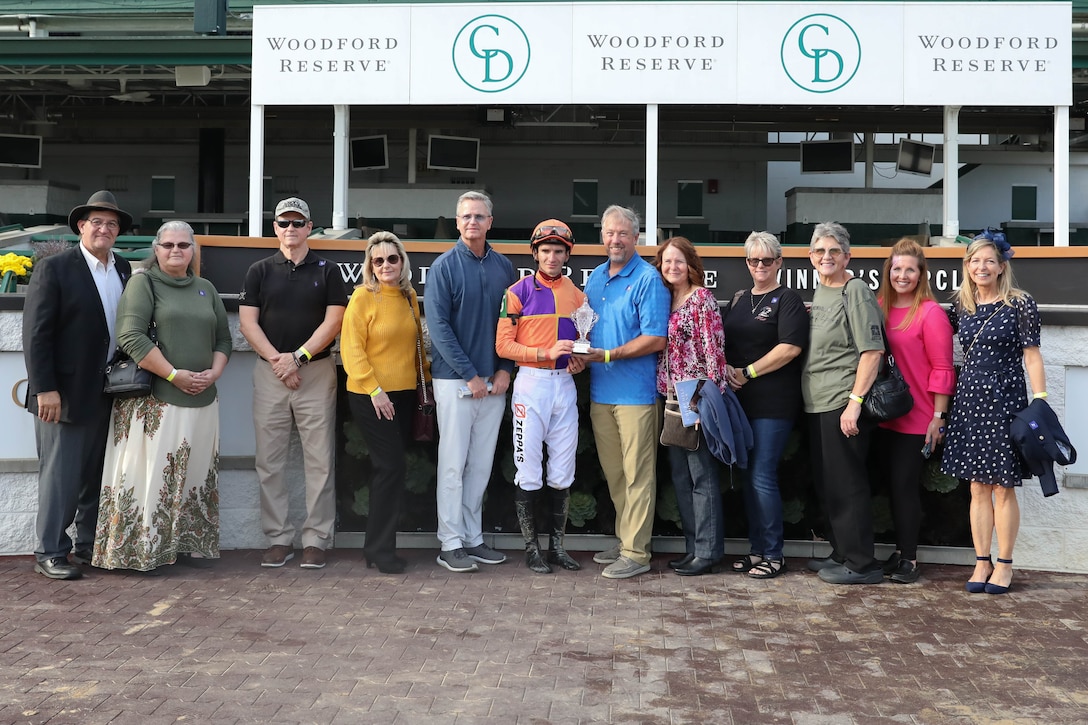 Gold Star family members gather in the Woodford Reserve Winners Circle at Churchill Downs during Survivors' Day at the Races to present a trophy to the winning horse in Louisville, Kentucky, Nov. 3, 2024. The United States Army Survivor Outreach Services team partners with Churchill Downs each year for this event.