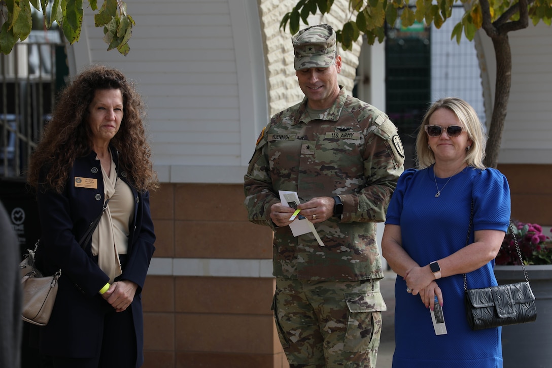 Brig. Gen. Muennich (center), the assistant adjutant general of the Indiana National Guard, collects his ticket and wristband for the Survivors' Day at the Races with his wife (right) and greets Bonnie Morales (left) at the Clubhouse Gate outside of Churchill Downs in Louisville, Kentucky, Nov. 3, 2024. The United States Army Survivor Outreach Services team partners with Churchill Downs each year for this event.