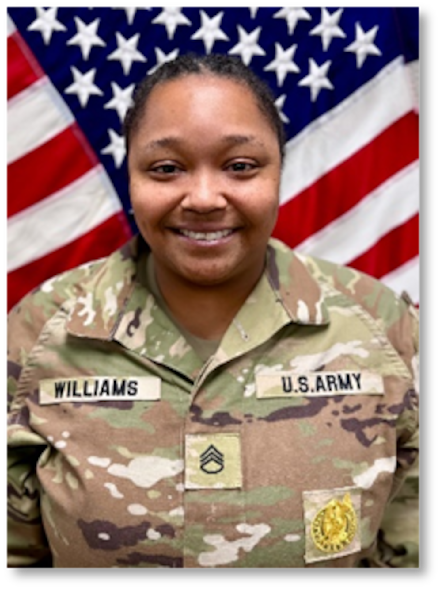 Female Soldier posed in front of U.S. flag