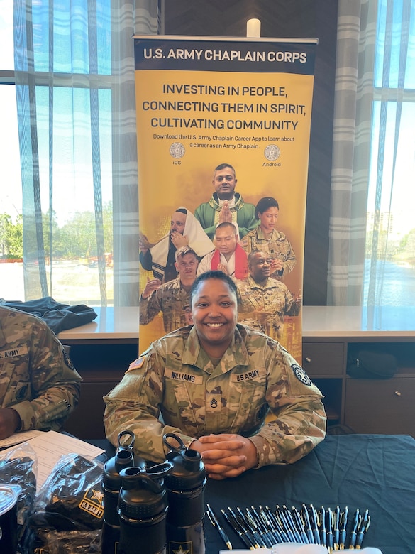 Female Soldier sitting at recruiting booth