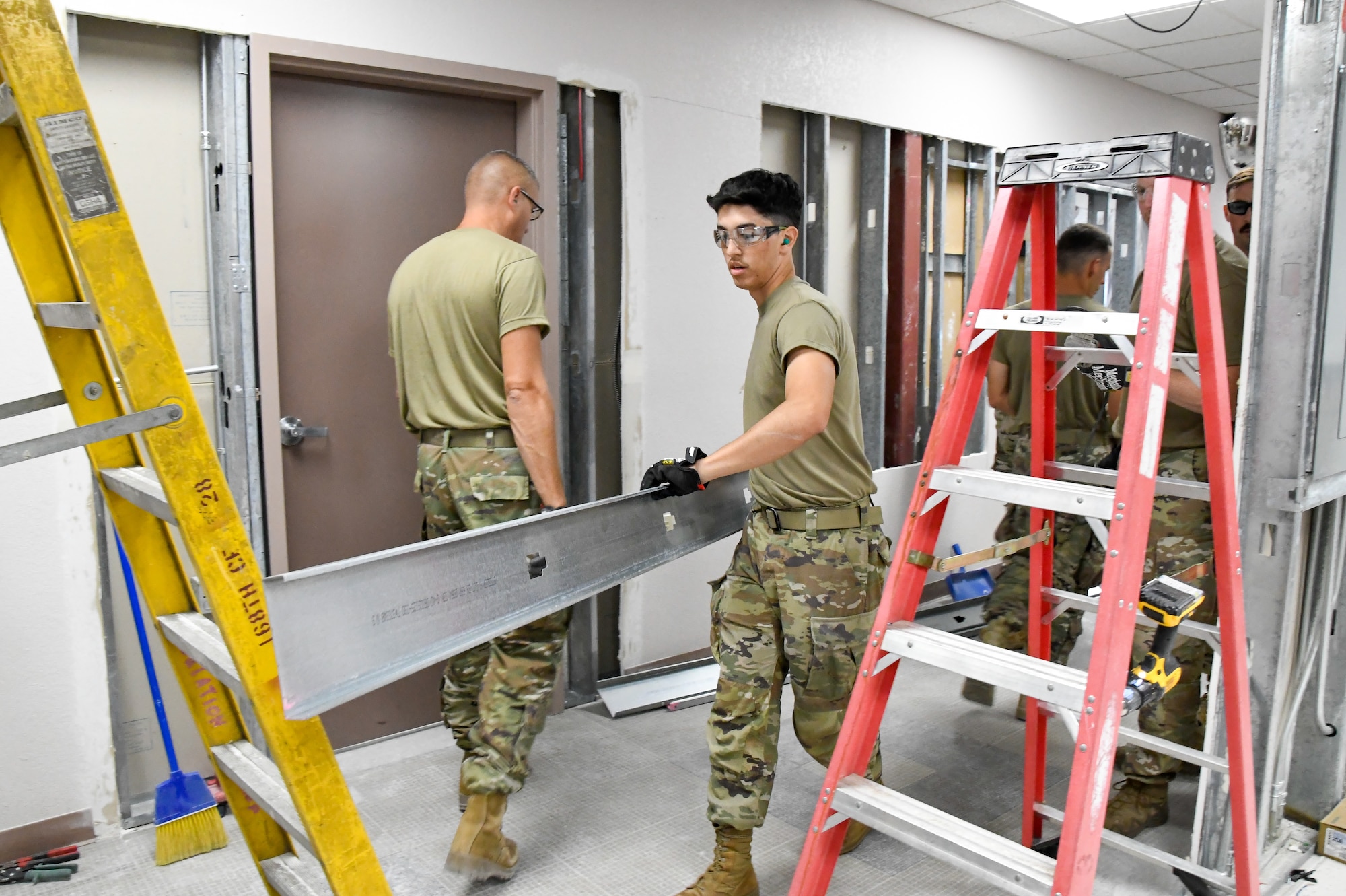 Airman 1st Class Martin Ramirez Wilches, 168th Wing Civil Engineering Structures, constructs a new doorway to improve the 168 CE flow of operations within the CES building .