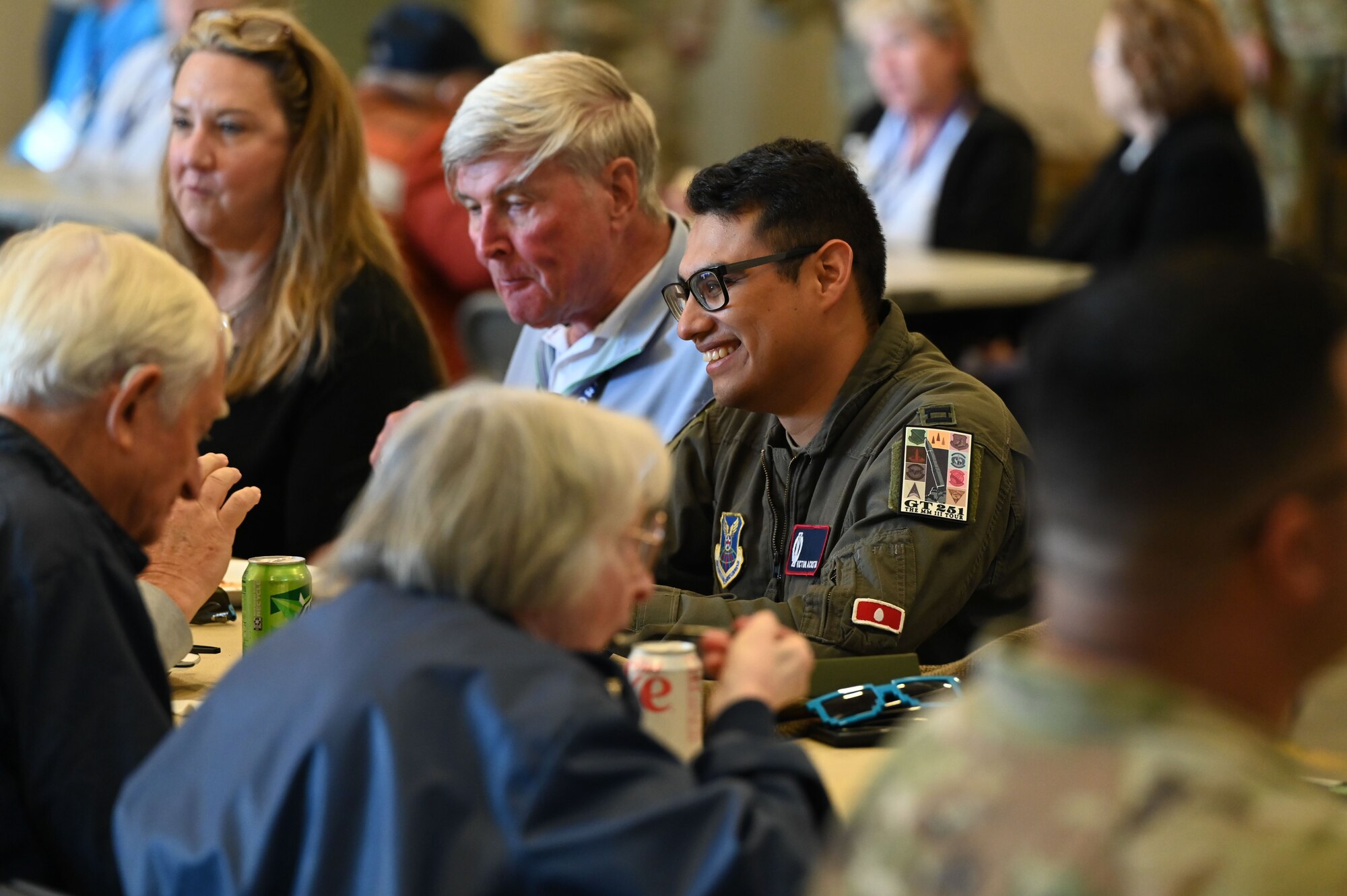 People eat lunch at a long table.