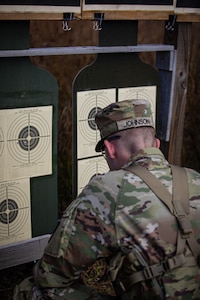 Spc. Zachary Johnson, a resident of Lexington, Oklahoma assigned to Camp Gruber Training Center as an interior electrician, reviews his targets after a stress shoot at the Oklahoma Army National Guard Best Warrior Competition at Camp Gruber Training Center, Oklahoma, Nov.7, 2024.  The OKARNG Best Warrior Competition is an annual event designed to test and recognize the skills, endurance and professionalism of the best Soldiers and NCOs within the organization. (Oklahoma National Guard photo by Spc. Cambrie Cannon)