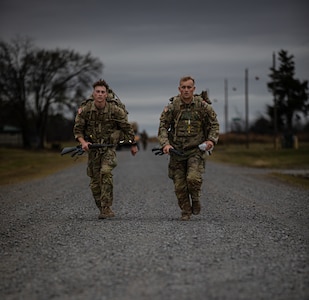 (left-right) Spc. Wesley McLin, a resident of Moore, Oklahoma, and Sgt. Bryce Hill, a resident of Tulsa, Oklahoma, complete the ruck march phase of the  Oklahoma Army National Guard Best Warrior Competition at Camp Gruber Training Center, Oklahoma, Nov. 8, 2024.  Both Soldiers are assigned to the 1st Battalion, 179th Infantry Regiment, 45th Infantry Brigade Combat Team and participated in the OKARNG Best Warrior Competition which aims to test and recognize the skills, endurance and professionalism of the best Soldiers and NCOs within the organization. (Oklahoma National Guard photo by Spc. Cambrie Cannon)