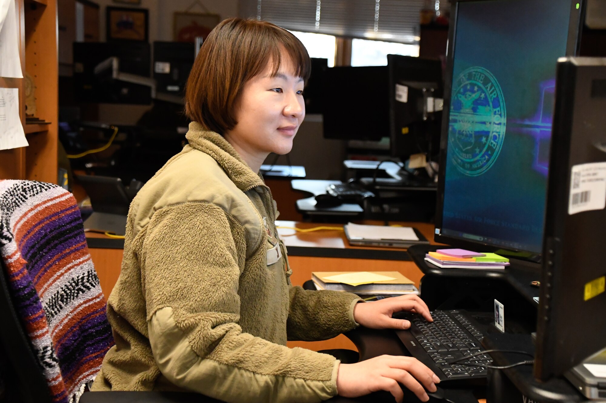 Senior Airman Yao Cai, 168th Wing financial operations technician, processes defense travel system authorizations.