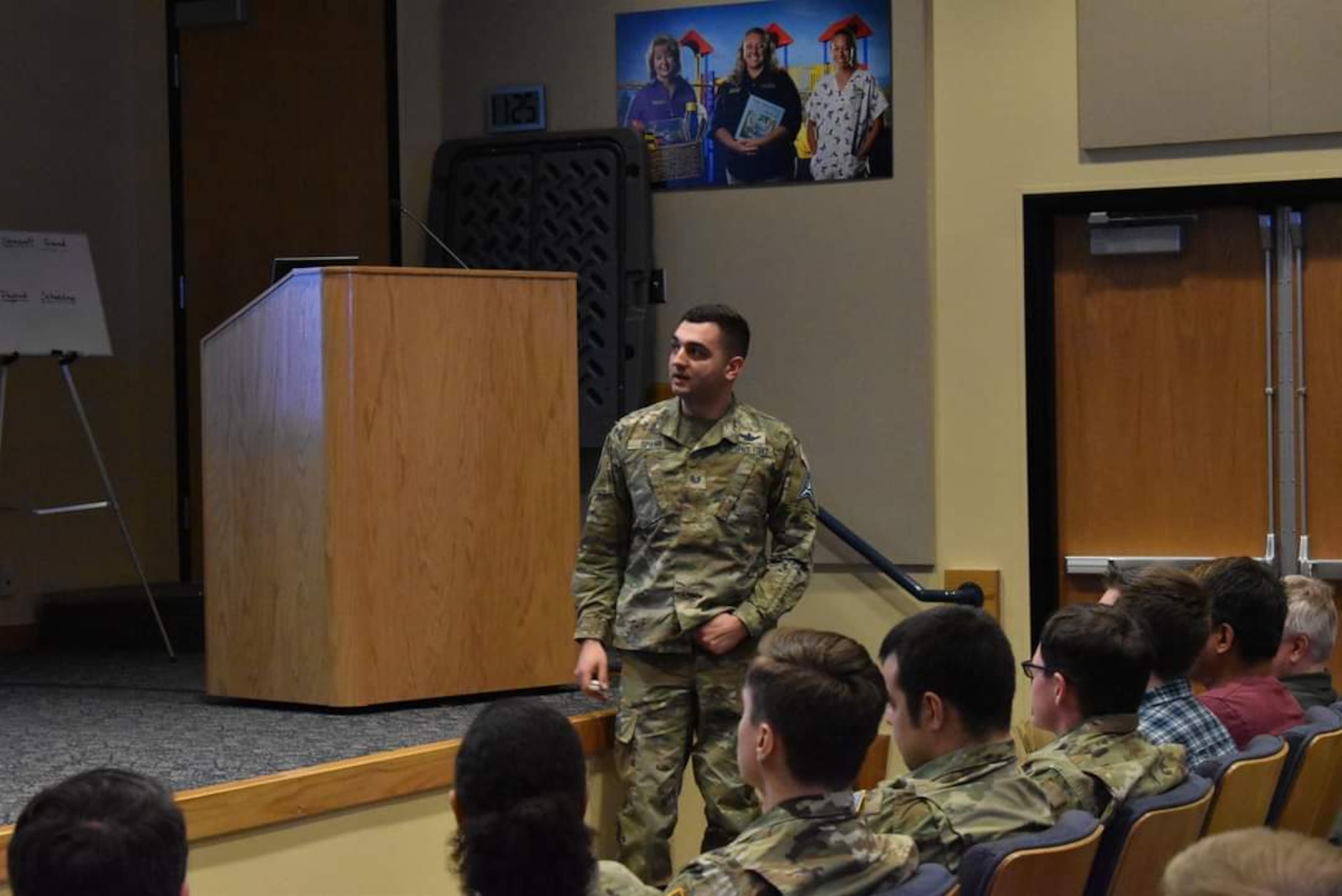 Uniformed members teaching a class in a lecture hall.