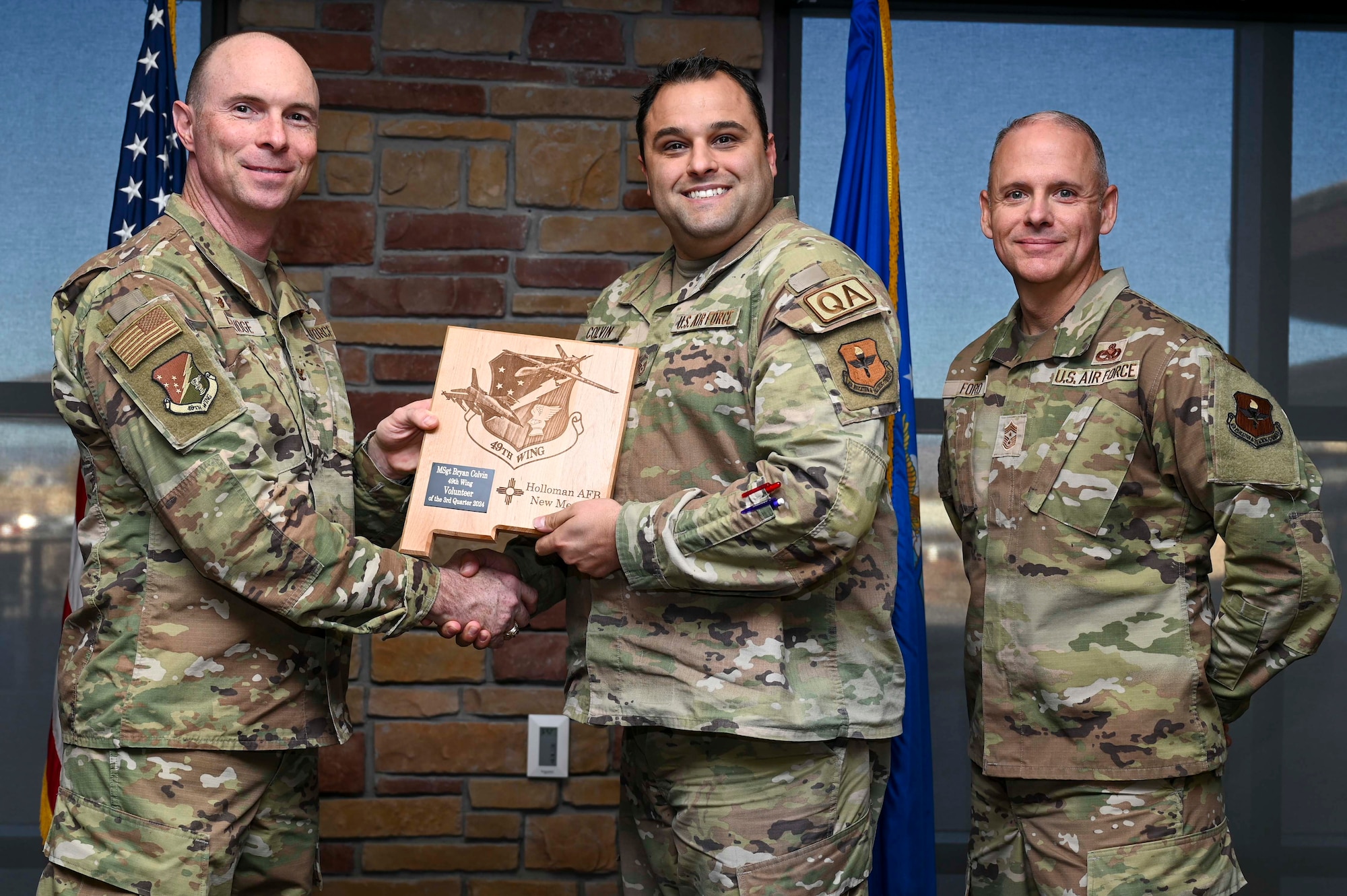 U.S. Air Force Master Sgt. Bryan Colvin, 49th Maintenance Group Quality Assurance chief inspector, accepts the 49th Wing’s Volunteer of the First Quarter Award, during the 49th Wing’s 3rd Quarter Award ceremony at Holloman Air Force Base, New Mexico, Nov. 8, 2024. Quarterly award winners were selected based on their technical expertise, demonstration of leadership and job performance. (U.S. Air Force photo by Airman 1st Class Michelle Ferrari)