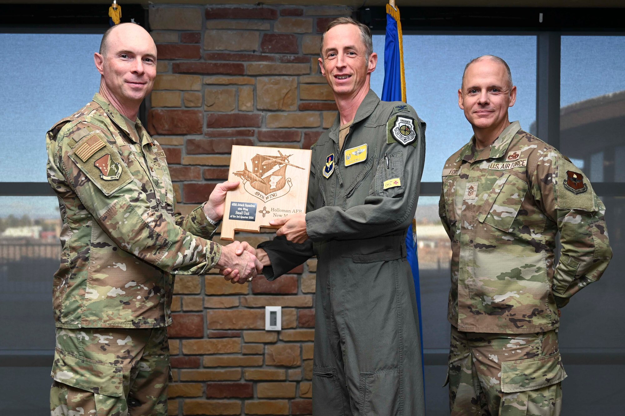 U.S. Air Force Col. Brad Howell, 49th Operations Group commander, accepts the 49th Wing’s Small Team of the Quarter Award on behalf of the 492nd Attack Squadron, during the 49th Wing’s 3rd Quarter Award ceremony at Holloman Air Force Base, New Mexico, Nov. 8, 2024. Quarterly award winners were selected based on their technical expertise, demonstration of leadership and job performance. (U.S. Air Force photo by Airman 1st Class Michelle Ferrari)