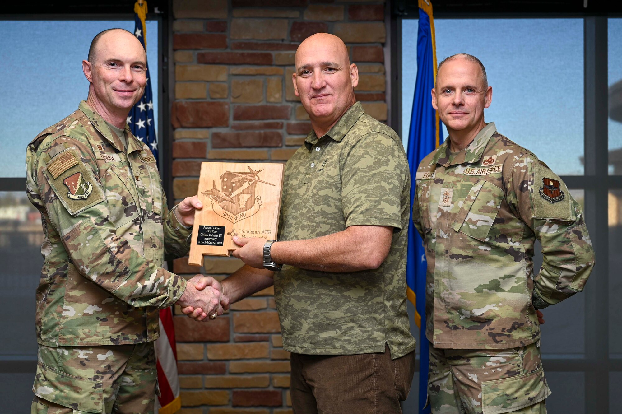 James Lashley, from the 49th Component Maintenance Squadron director of operations, accepts the 49th Wing Category III Supervisory Civilian of the Quarter Award, during the 49th Wing’s 3rd Quarter Award ceremony at Holloman Air Force Base, New Mexico, Nov. 8, 2024. Quarterly award winners were selected based on their technical expertise, demonstration of leadership and job performance. (U.S. Air Force photo by Airman 1st Class Michelle Ferrari)