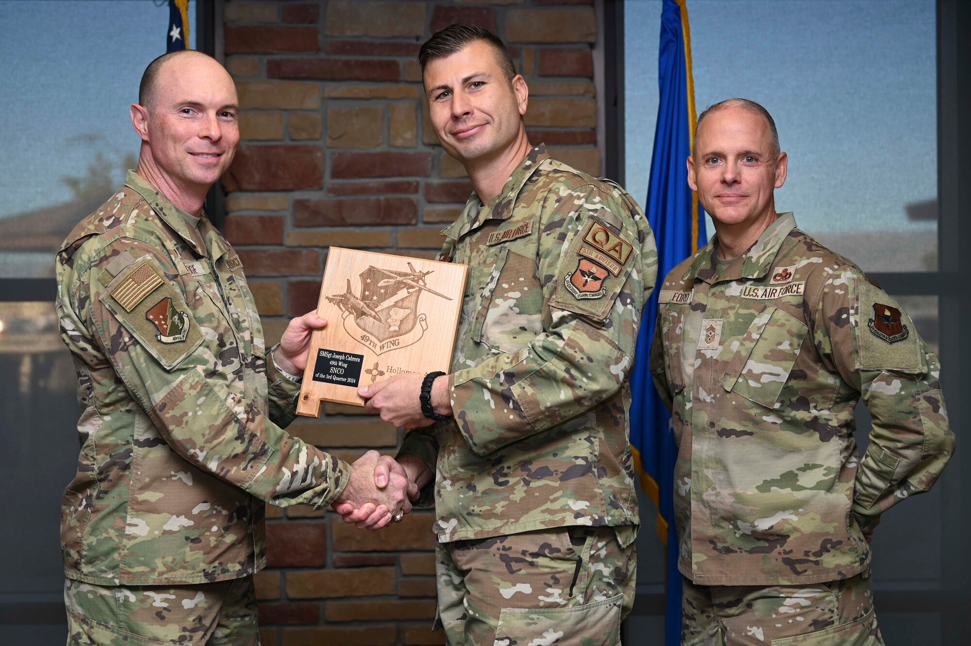 U.S. Air Force Senior Master Sgt. Joseph Cabrera, 49th Maintenance Group Quality Assurance superintendent, accepts the 49th Wing Senior Noncomissioned Officer of the Quarter Award, during the 49th Wing’s 3rd Quarter Award ceremony at Holloman Air Force Base, New Mexico, Nov. 8, 2024. Quarterly award winners were selected based on their technical expertise, demonstration of leadership and job performance. (U.S. Air Force photo by Airman 1st Class Michelle Ferrari)