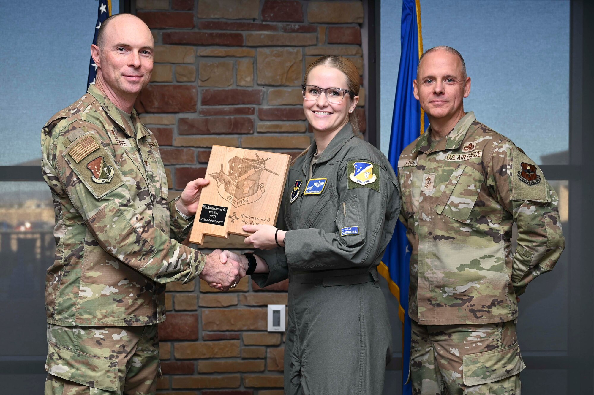 U.S. Air Force Tech. Sgt. Autumn Hedrick-Cox, 49th Operations Group international military staff flight chief, accepts the 49th Wing Noncomissioned Officer of the Quarter Award, during the 49th Wing’s 3rd Quarter Award ceremony at Holloman Air Force Base, New Mexico, Nov. 8, 2024. Quarterly award winners were selected based on their technical expertise, demonstration of leadership and job performance. (U.S. Air Force photo by Airman 1st Class Michelle Ferrari)