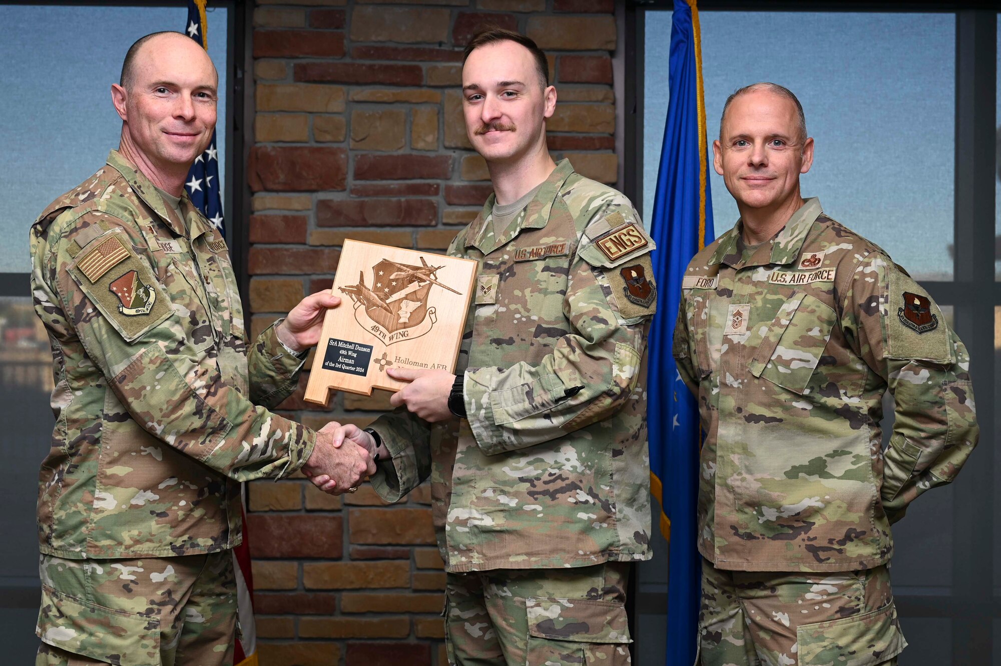 U.S. Air Force Senior Airman Mitchell Dunson, 49th Component Maintenance Squadron aerospace propulsion journeyman, accepts the 49th Wing Airman of the Quarter Award, during the 49th Wing’s 3rd Quarter Award ceremony at Holloman Air Force Base, New Mexico, Nov. 8, 2024. Quarterly award winners were selected based on their technical expertise, demonstration of leadership and job performance. (U.S. Air Force photo by Airman 1st Class Michelle Ferrari)