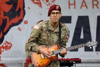 A guitar player with the 82nd Airborne Division Rock Band performs for football fans at Soldier Field in Chicago before the start of the Chicago Bears versus New England Patriots game which honored our nation’s military veterans on November 1, 2024.