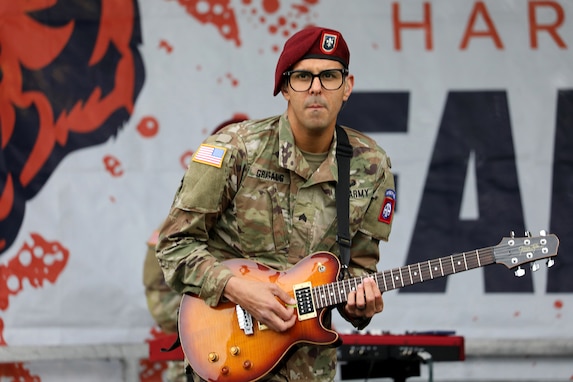 A guitar player with the 82nd Airborne Division Rock Band performs for football fans at Soldier Field in Chicago before the start of the Chicago Bears versus New England Patriots game which honored our nation’s military veterans on November 1, 2024.