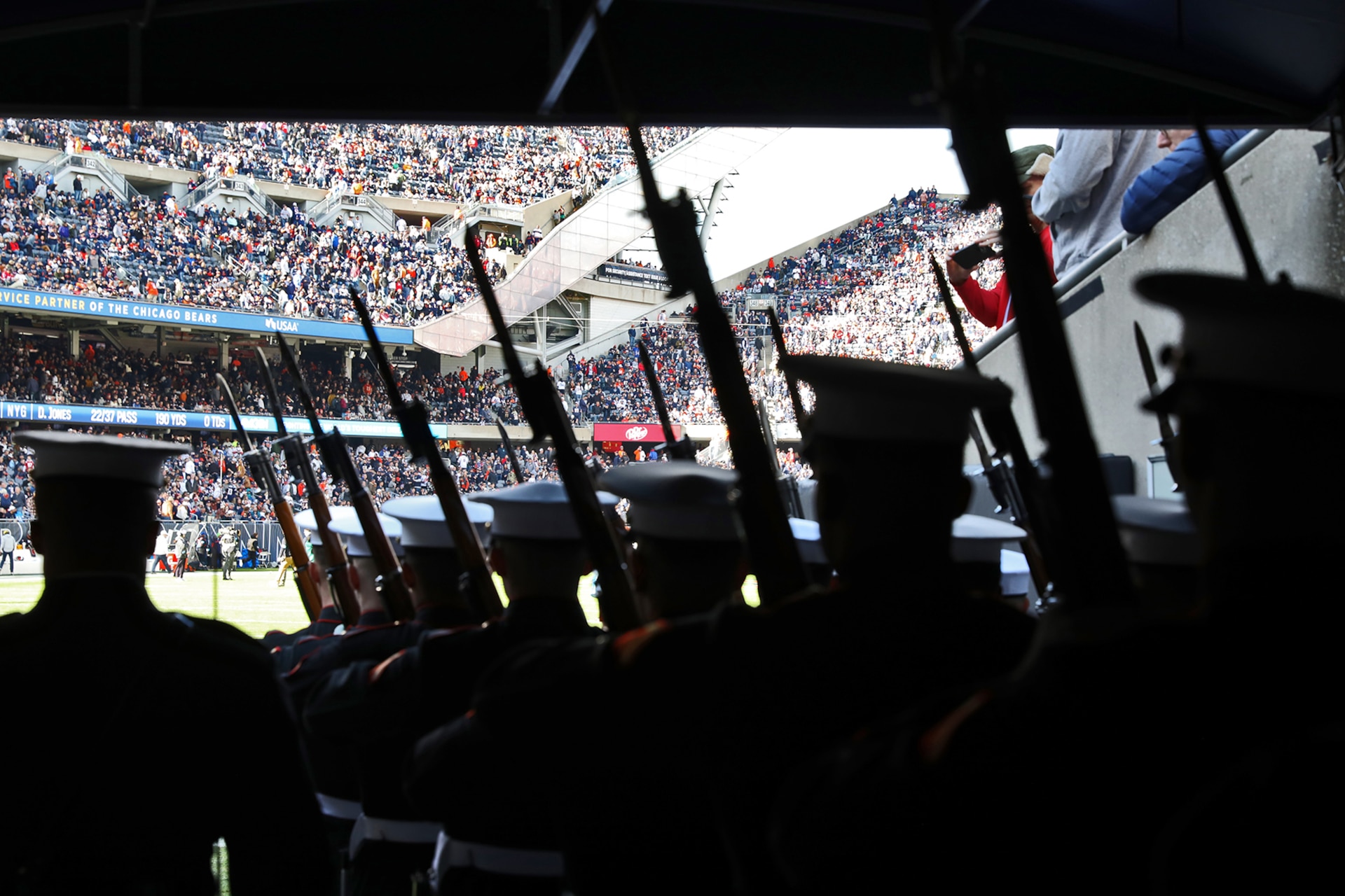 Members of the United States Marine Corps Silent Drill Platoon prepare to step onto Soldier Field for the half time performance of the Chicago Bears versus New England Patriots game on November 10, 2024.
